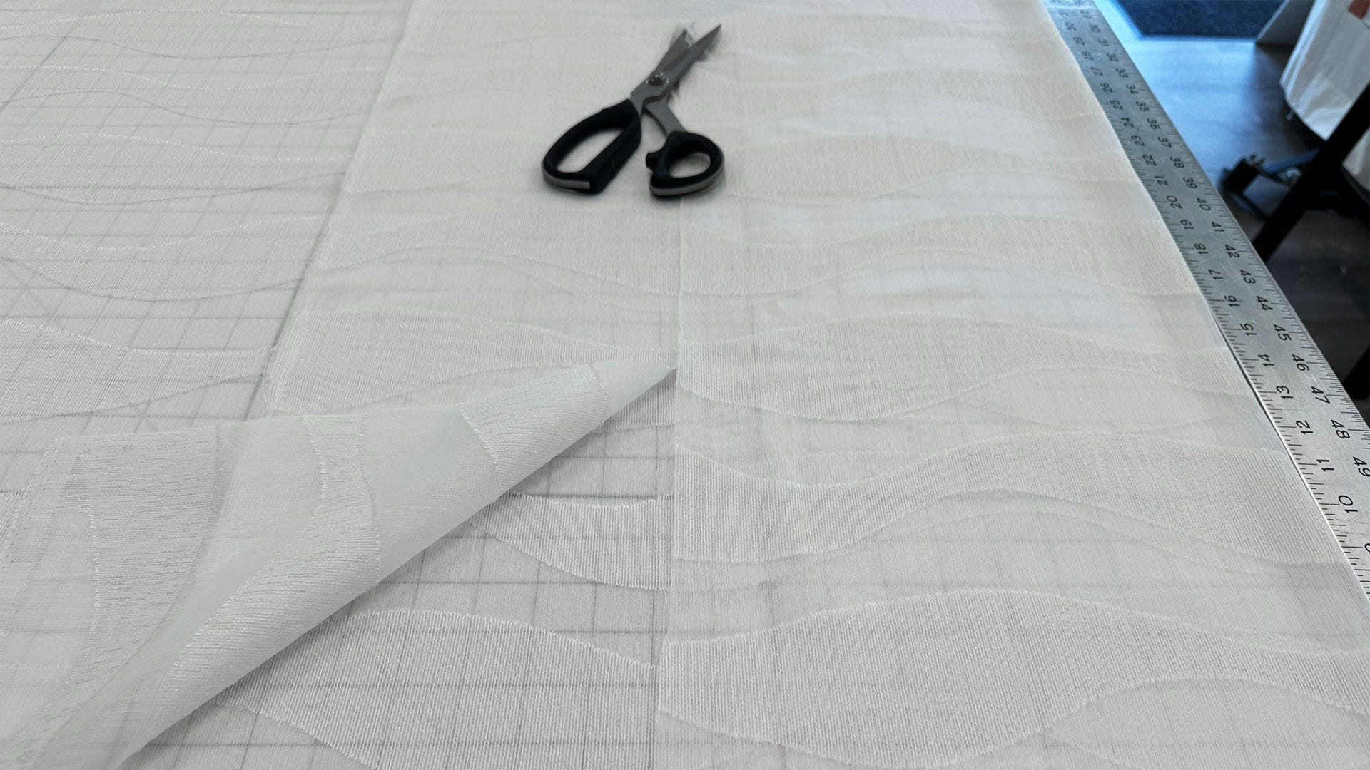 Preparing fabric for creating the header of inner sheer panels.