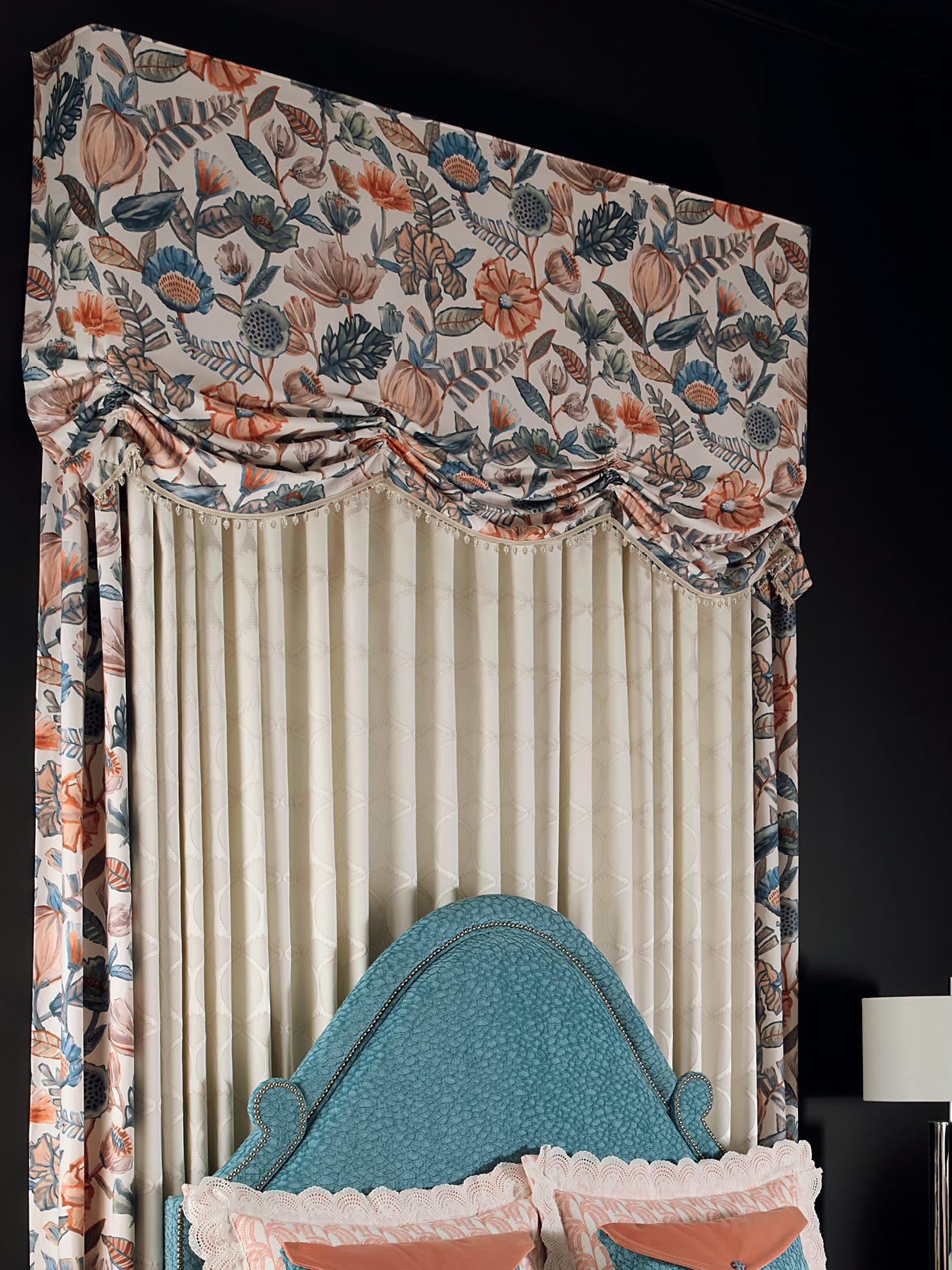Angled shot of upholstered headboard with over-the-bed valance and panels.